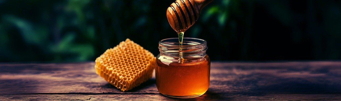 honey dripping in to a jar